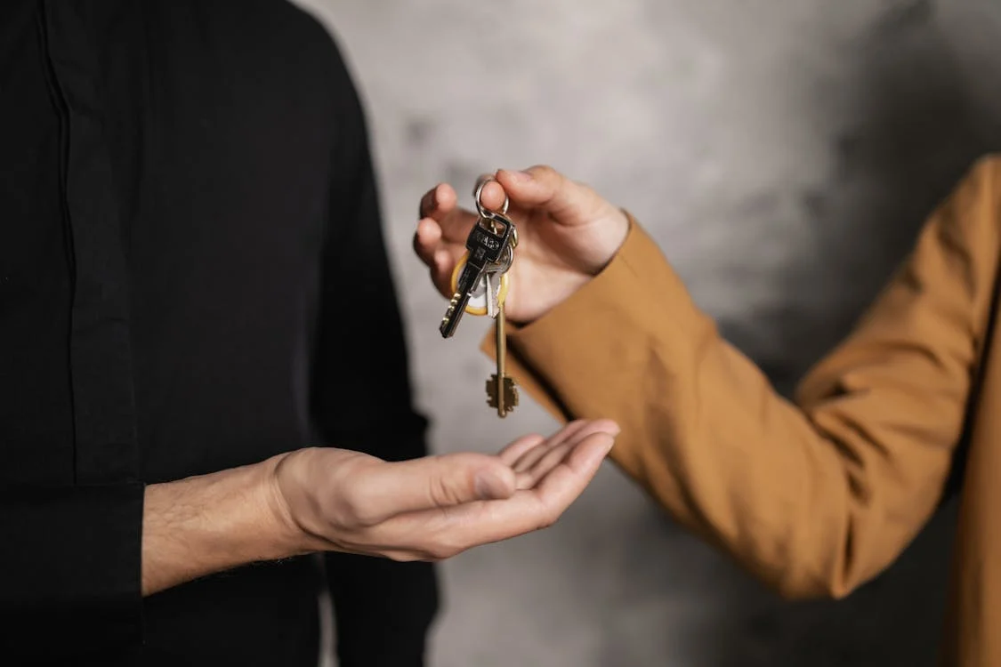 keys being handed to another person