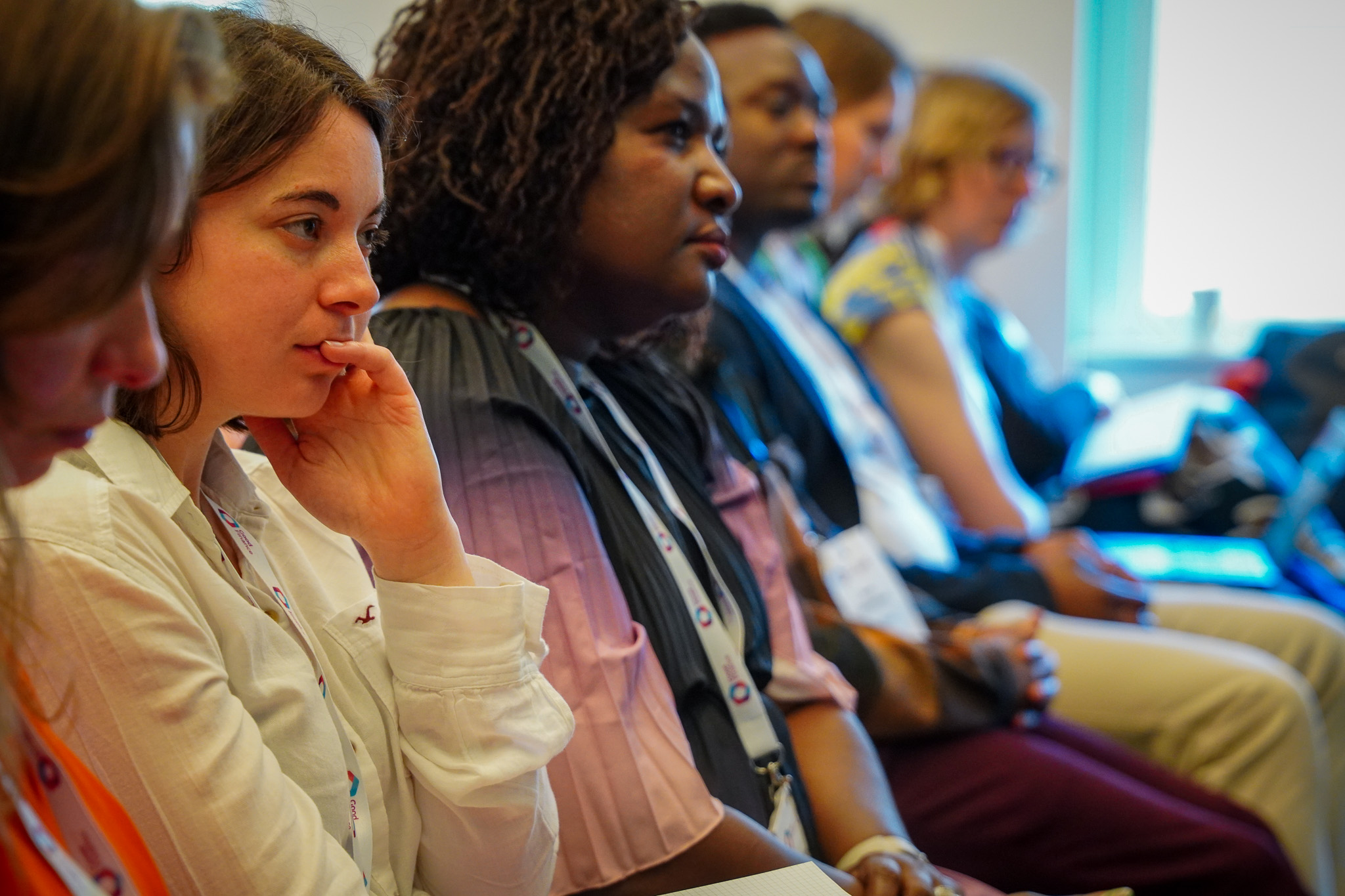 The image shows a close up of 2 women in an audience.