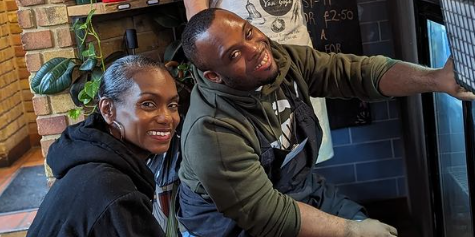 Image shows 3 people behind the desk at a cafe