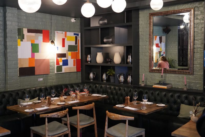 The image shows a cosy fine-dining restaurant