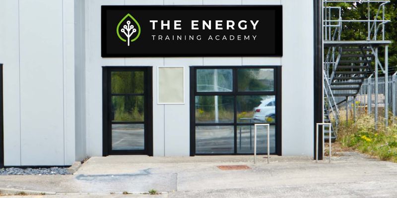 Image of 2 storey white building with black sign and white lettering reading The Energy Training Academy